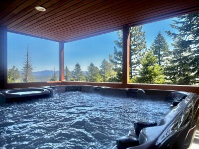 Covered Deck Spa Overlooking a Dense Pine Forest